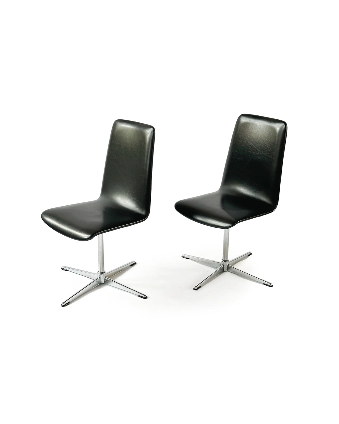 Vintage chrome swivel chairs in black vinyl